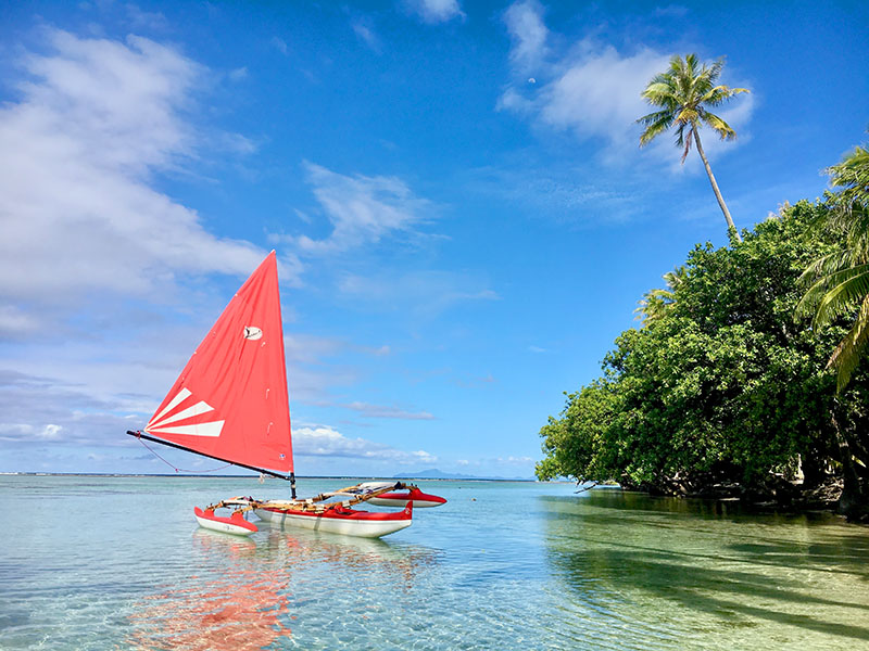 Pahi sailing canoes fushing in the lagoon of Rajatea. In the